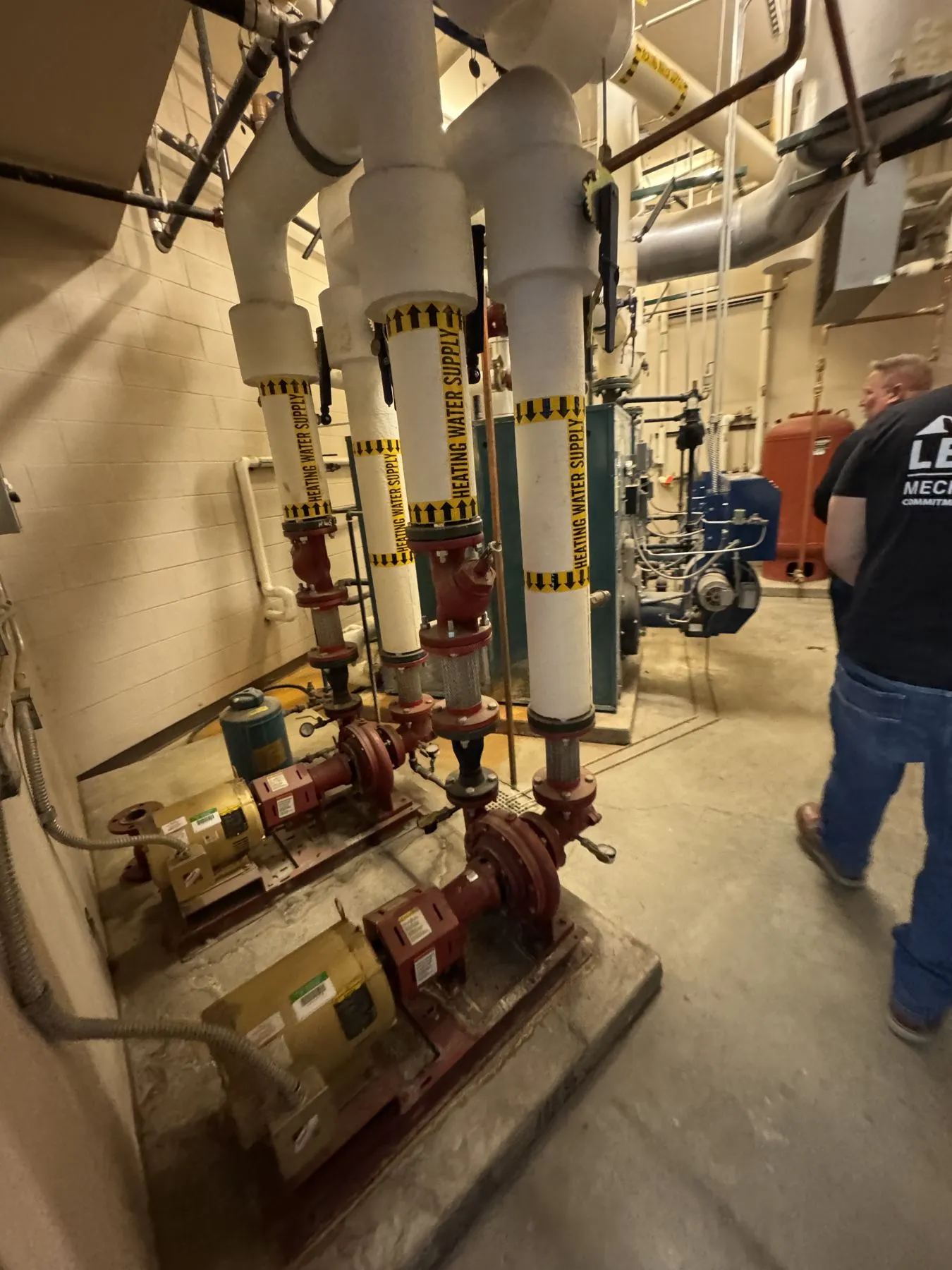 Cast iron boiler plant in a school mechanical room before same-day demolition