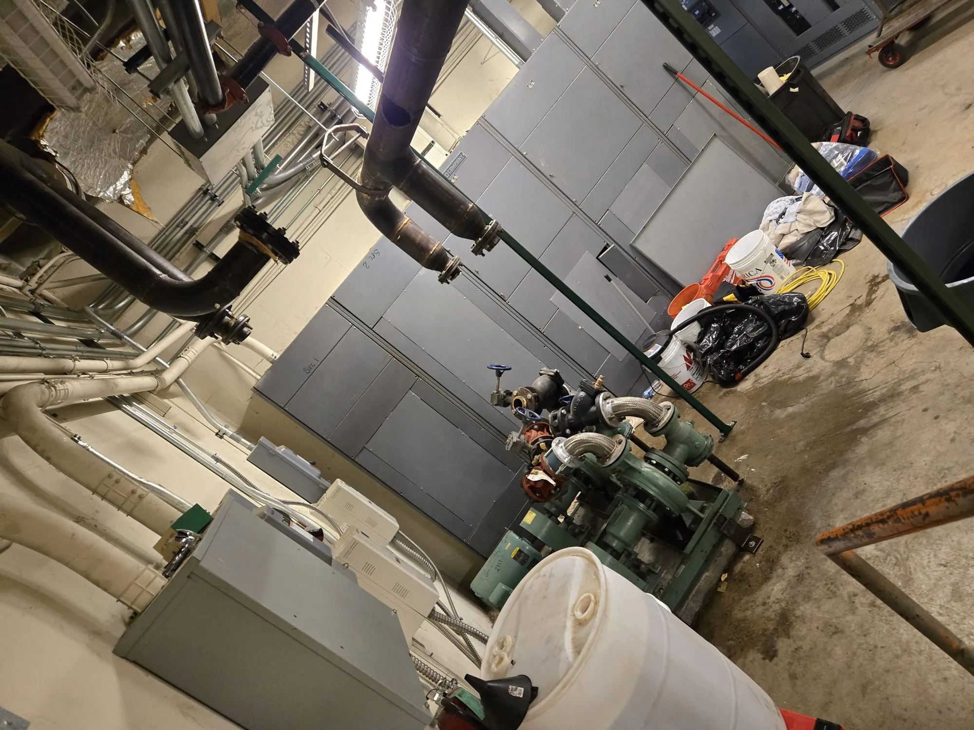 Mechanical room piping, pumps and tanks staged for removal