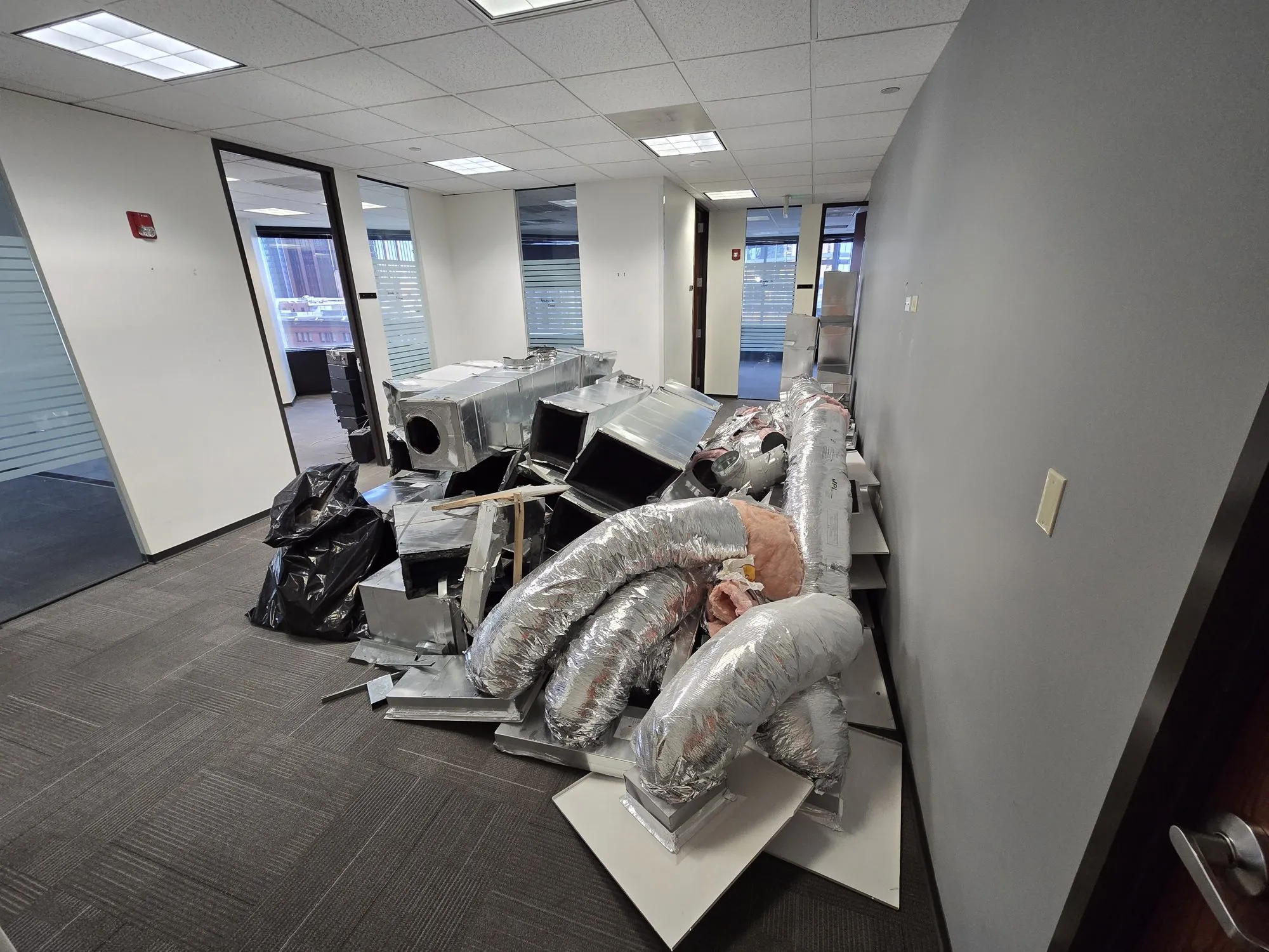 Sectioned HVAC equipment staged on the eleventh floor of a high-rise for haul-out